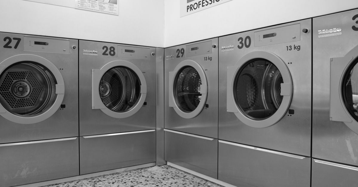 A sleek row of industrial washing machines in a modern laundromat, conveying efficiency and cleanliness.