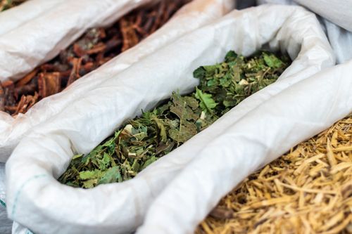Free Close-up of assorted dried herbal leaves and bark in burlap sacks in São Paulo market. Stock Photo
