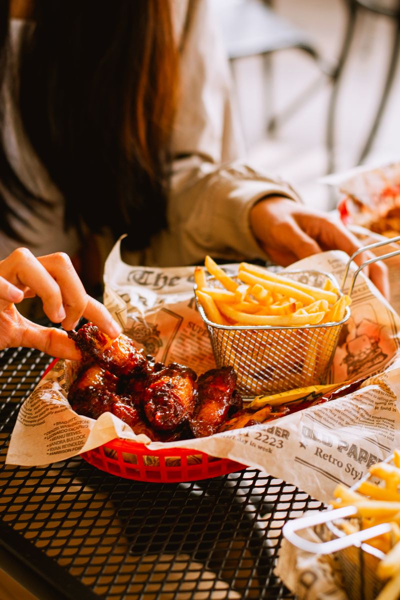 Illustrative basket of chicken wings and fries; not a photograph of Brick & Fire's wings