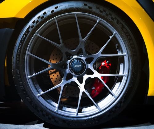 Free Detailed view of a sports car wheel and brake system featuring a RS rim, perfect for automotive enthusiasts. Stock Photo