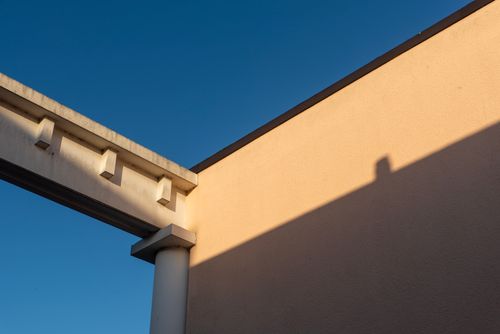 Free Minimalist architecture with dramatic shadows and vivid blue sky. Stock Photo