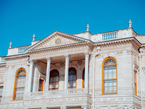 Free A stunning view of an intricate, historical building facade under a vibrant blue sky in Istanbul, Turkey. Stock Photo