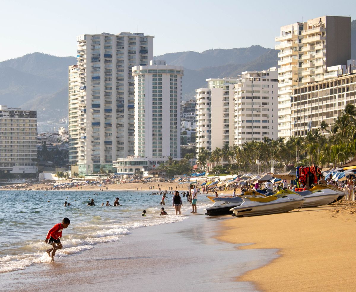 Acapulco beachfront with high-rise hotels and the sweeping bay in the background