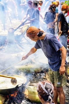 People cooking outdoors in Central Java, Indonesia during a traditional gathering.