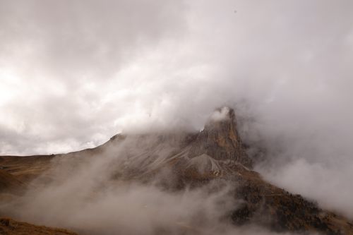 Free Dramatic view of the mist-covered Dolomite peaks enveloped in clouds during the day. Stock Photo