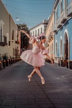 Elegant ballerina dancing on a picturesque street in Puebla, showcasing grace and historic architecture.