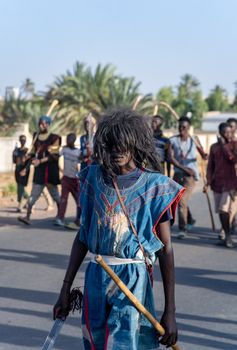 Participants in vibrant traditional attire during a cultural festival parade in Dutse, Nigeria.