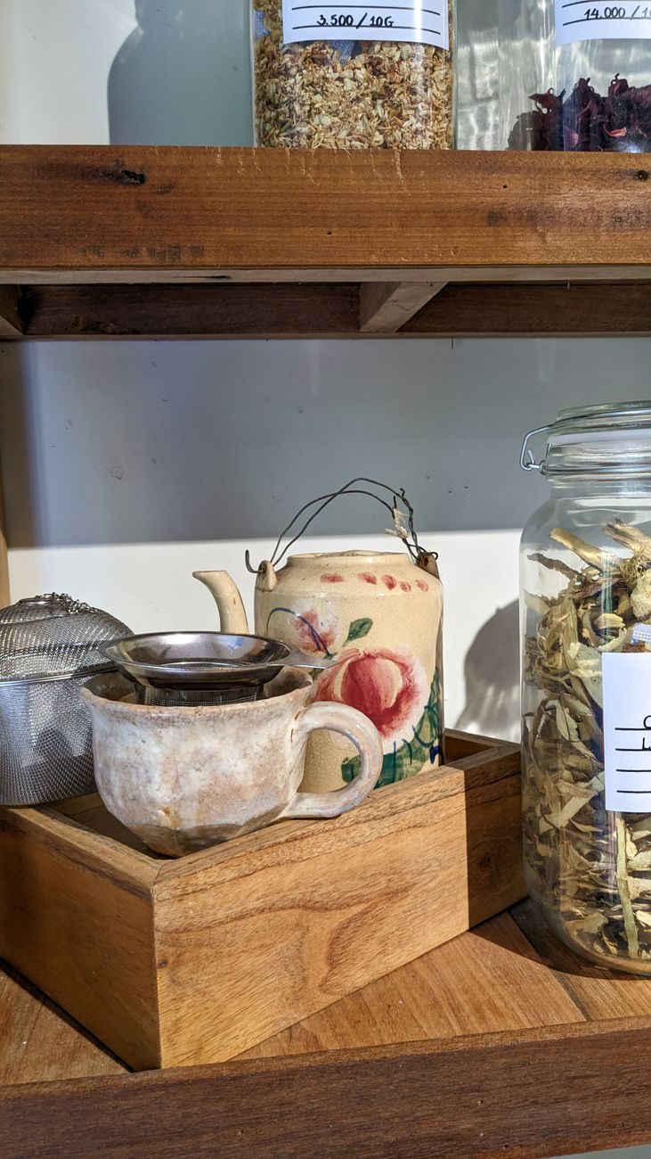 Loose leaf tea brewing in a glass teapot