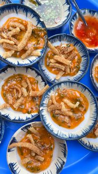 A close-up of traditional Vietnamese savory rice cakes in colorful bowls.