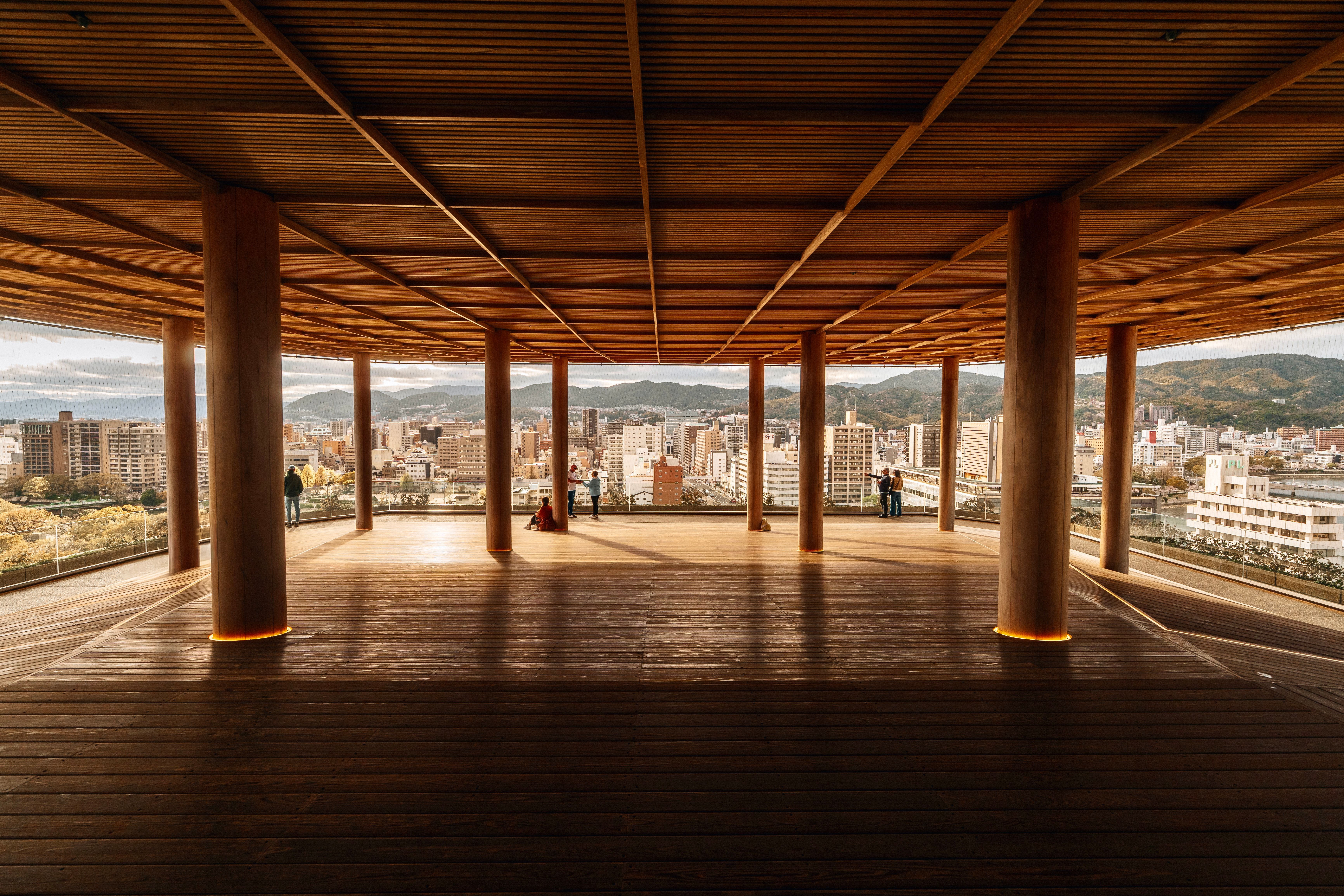 A wooden architectural space with city view in Hiroshima, Japan, featuring a modern and minimalist design.