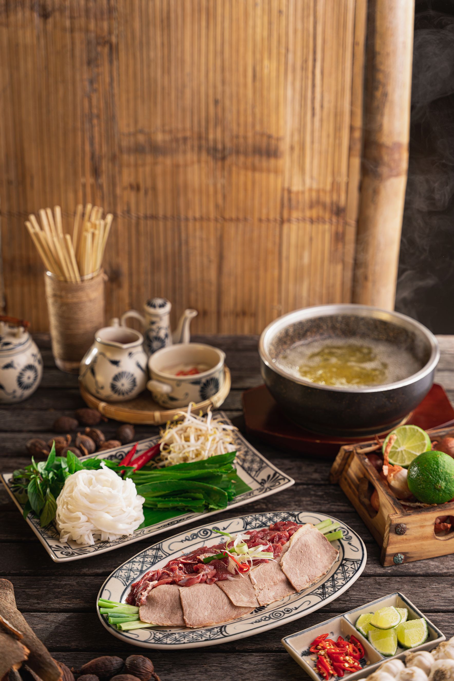 An appetizing setup of traditional Asian hot pot ingredients, showcasing fresh meats, vegetables, and aromatic herbs.