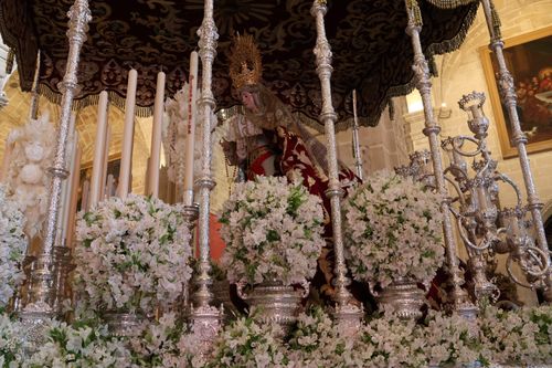Free A beautiful depiction of a Semana Santa procession altar adorned with flowers and candles. Stock Photo