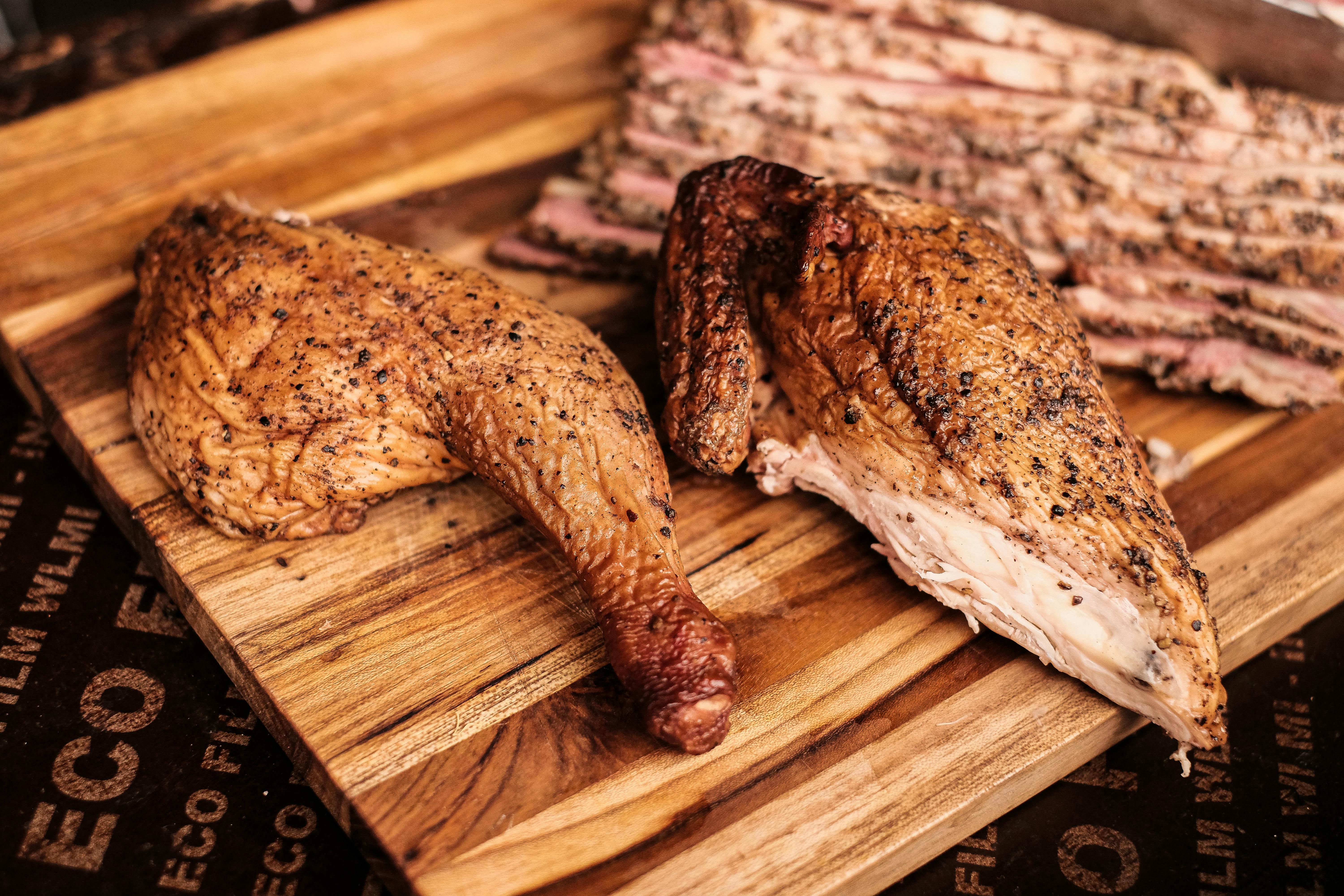 Inserting thermometer probe into chicken thigh at correct angle for accurate reading