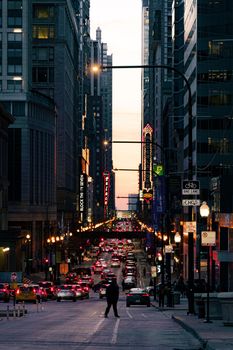 Vibrant city life on Chicago's streets by night, showcasing architecture and bustling traffic.