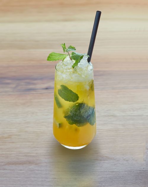 Free A refreshing mint mojito cocktail with ice and mint leaves on a wooden table. Stock Photo