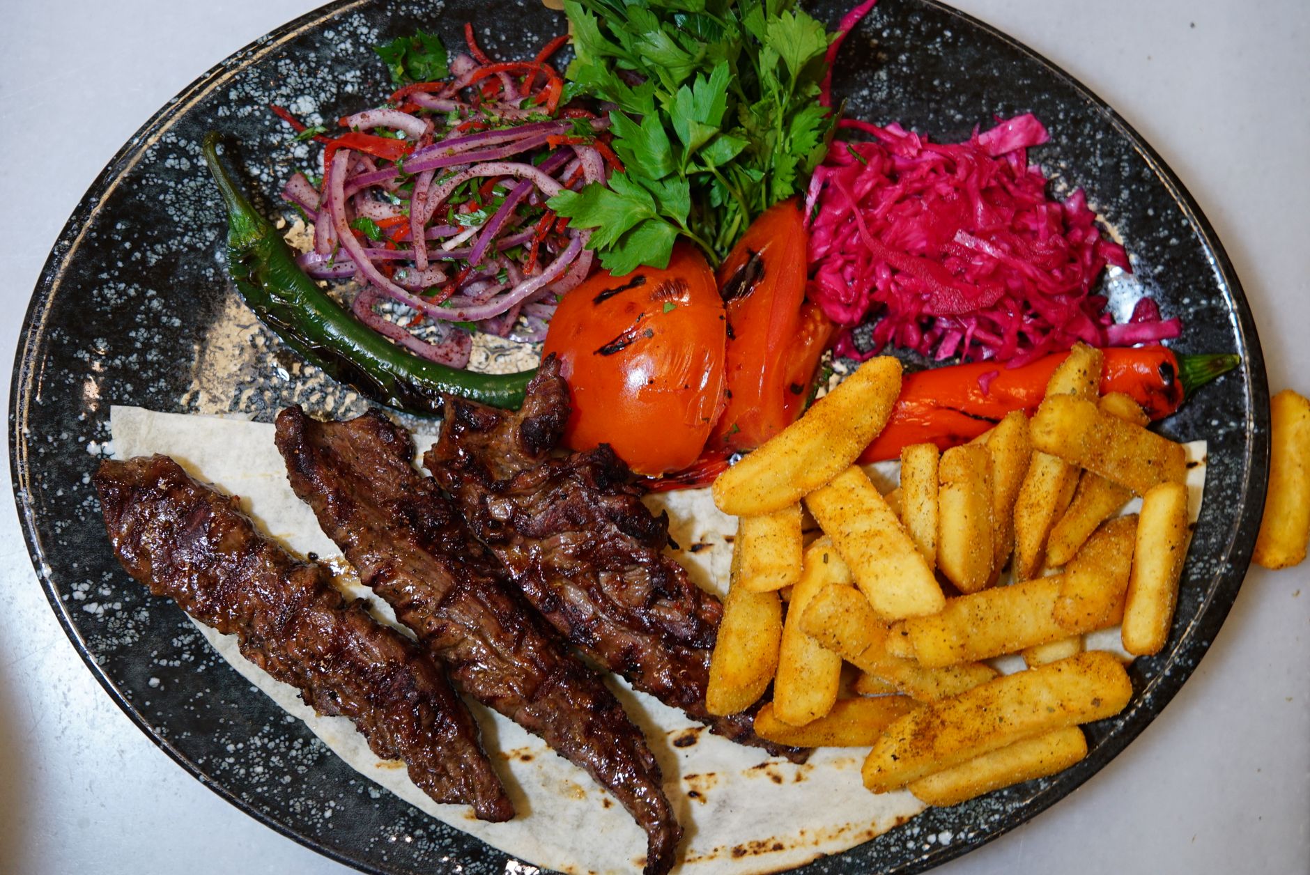West African feast spread with Jollof rice, plantains and grilled meat
