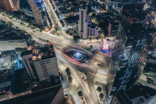 A stunning aerial view of a bustling intersection in Mexico City at night, with bright city lights and modern architecture.
