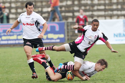 Men in White and Red Jersey Shirt Playing Soccer