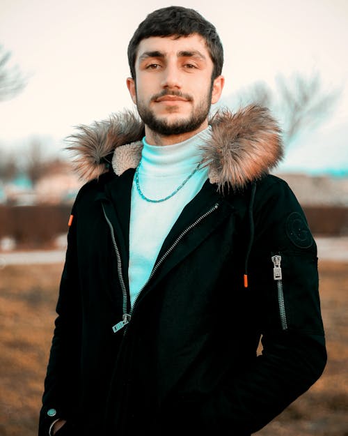 Man in Black Jacket and Gray Scarf