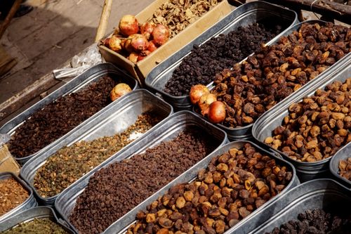 Free A lively market stall in Pakistan offering a variety of dried fruits and spices, showcasing cultural richness. Stock Photo