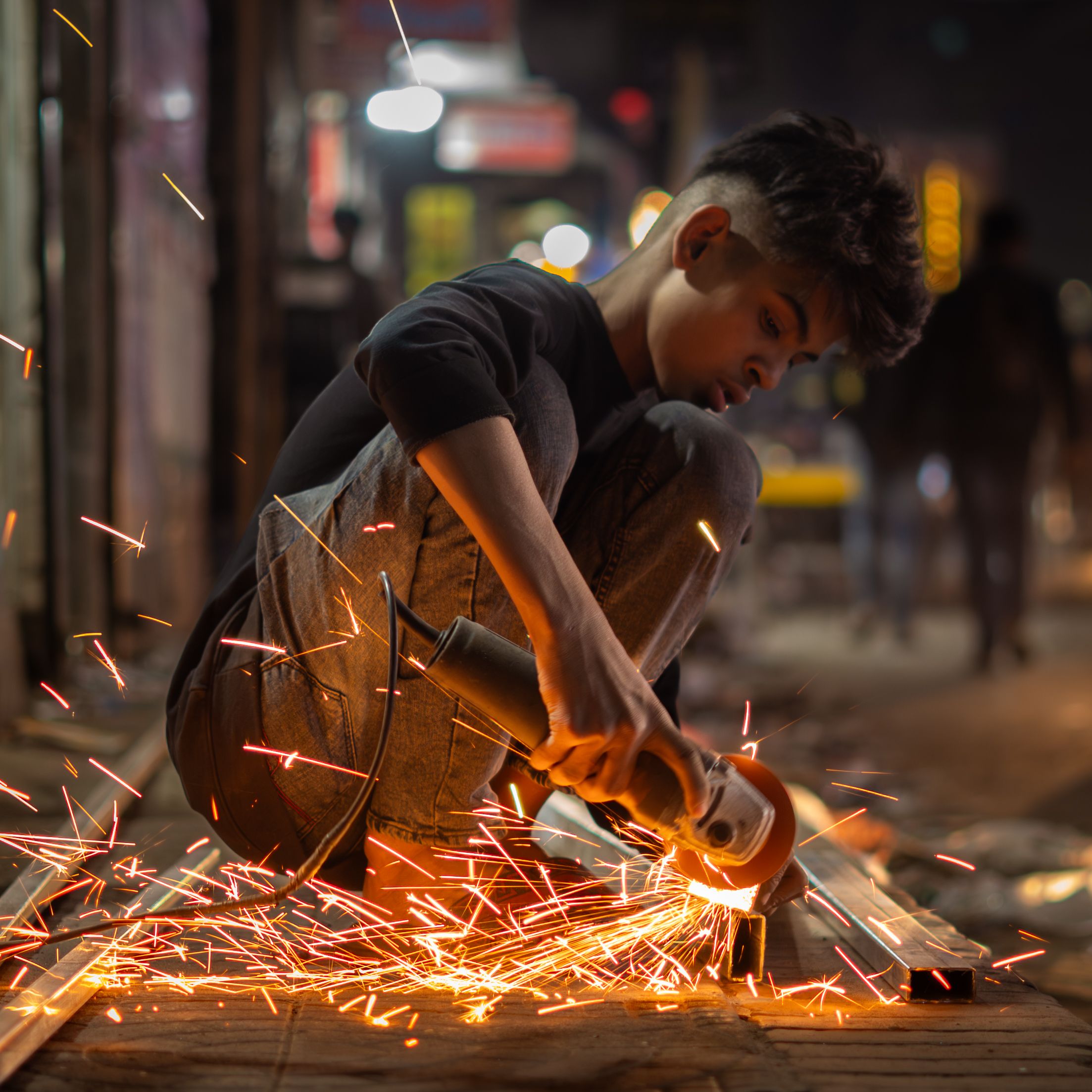 Person Using Angle Grinder Outdoors · Free Stock Photo