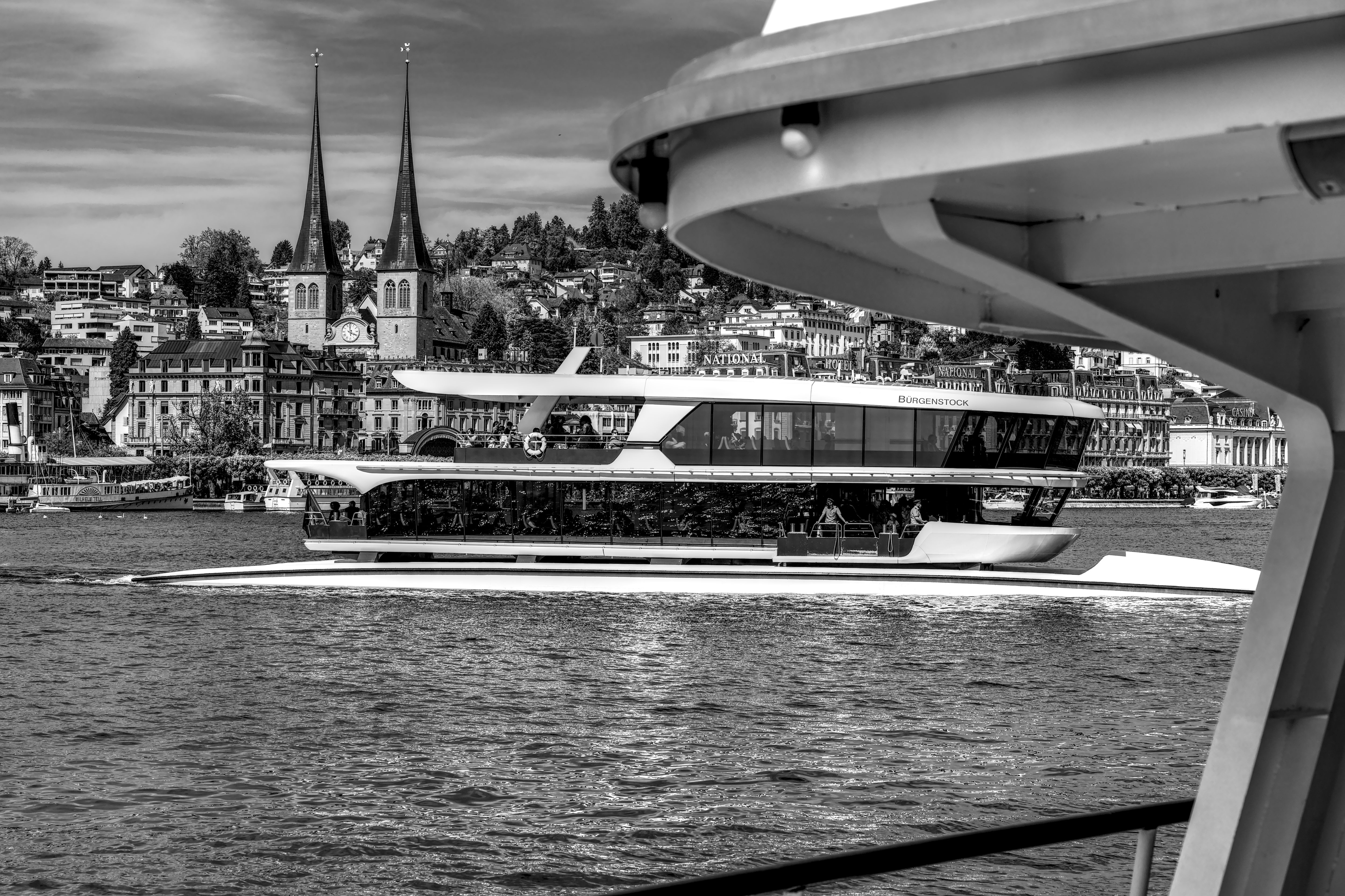 Modern Boat on Lake Lucerne with Historic Cityscape