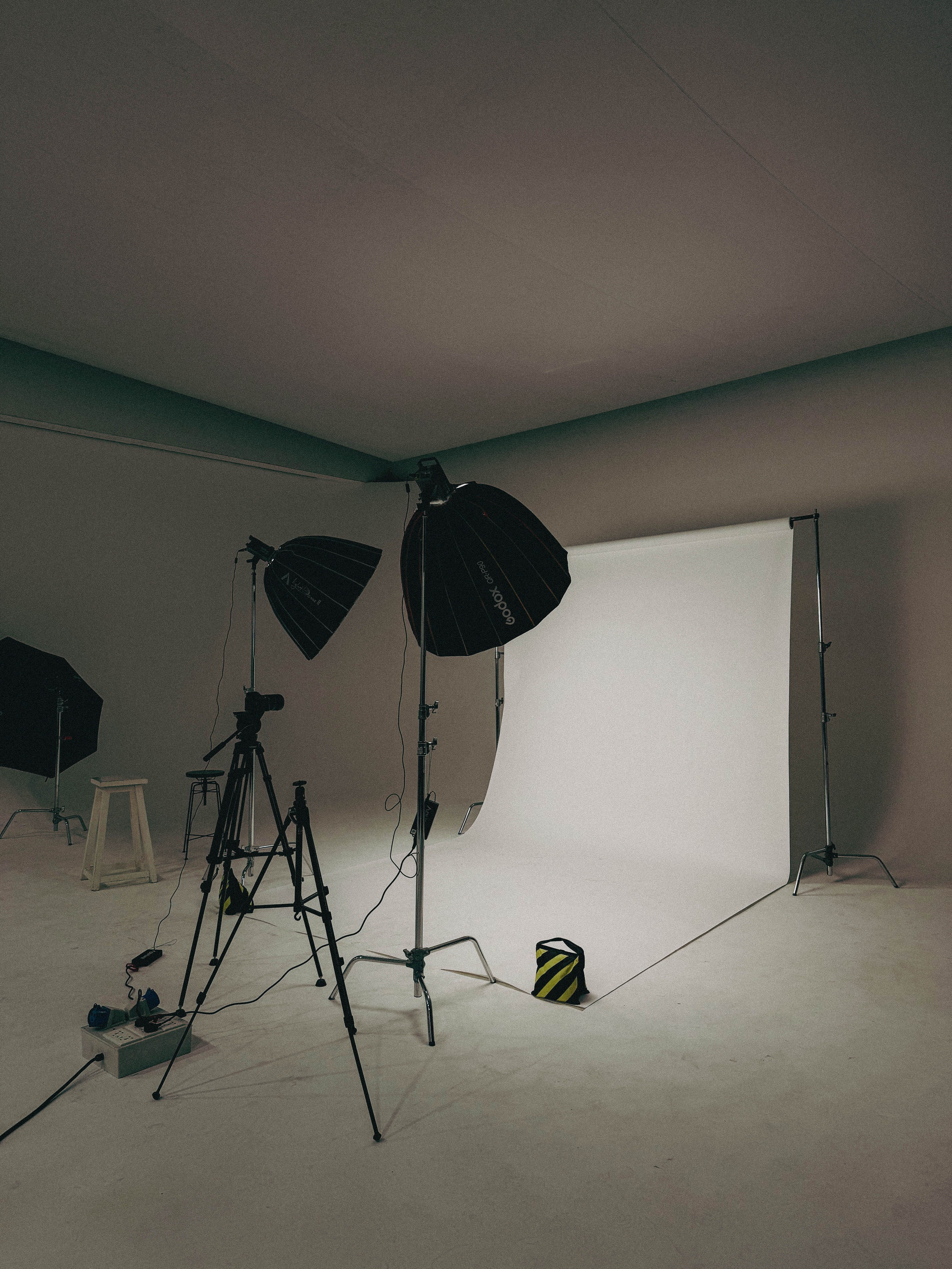 Spacious photography studio in Dubai with lights and backdrop ready for shooting.