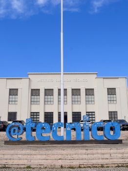 Front view of Instituto Superior Técnico in Lisbon with blue skies and modern architecture.