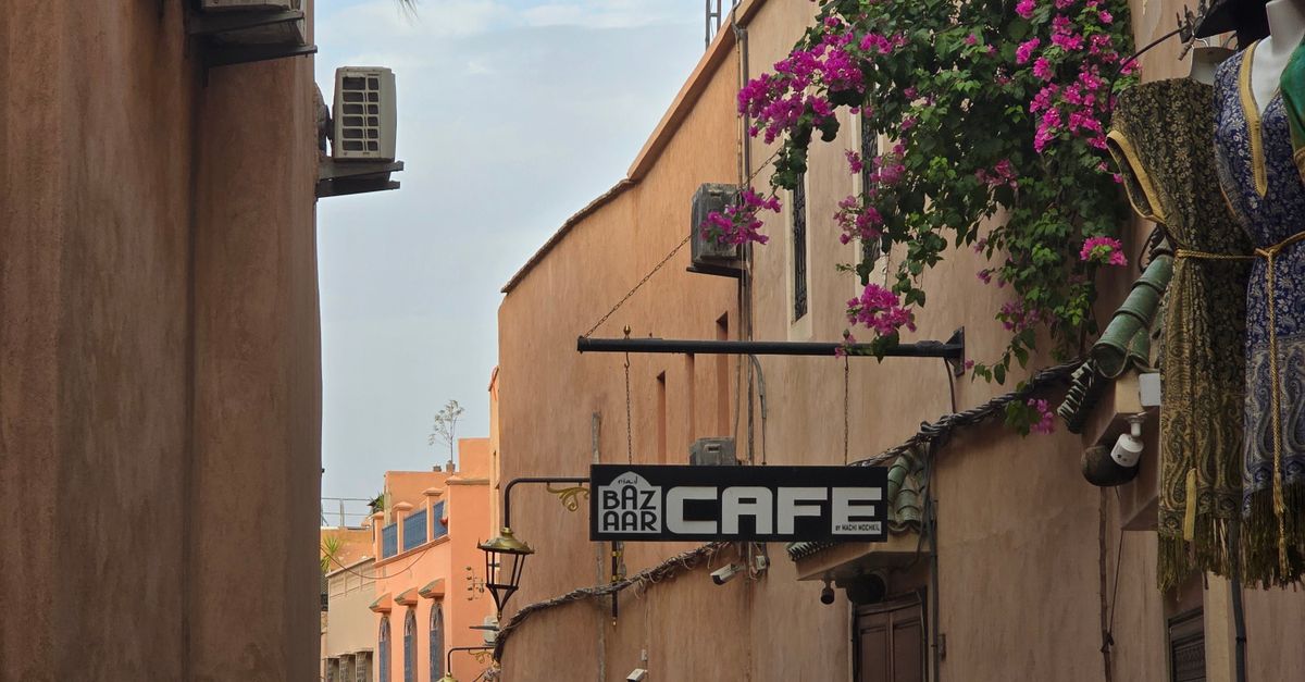 Discover a quaint alleyway with a café in the historic Medina of Marrakech, Morocco, offering local color and culture.