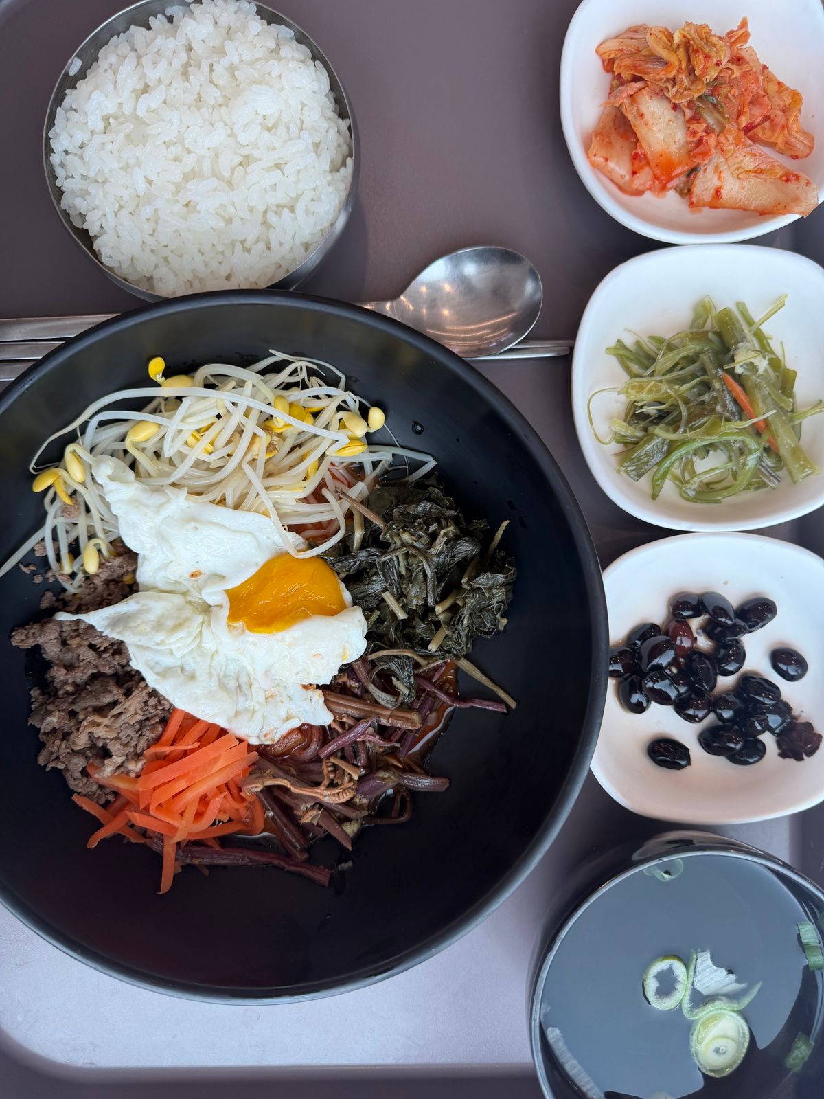 Bibimbap with an egg and several side dishes