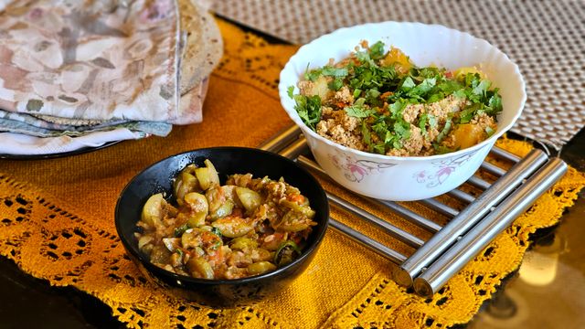 Authentic Indian dishes including chapati, vegetable curry, and chutney served on a table.