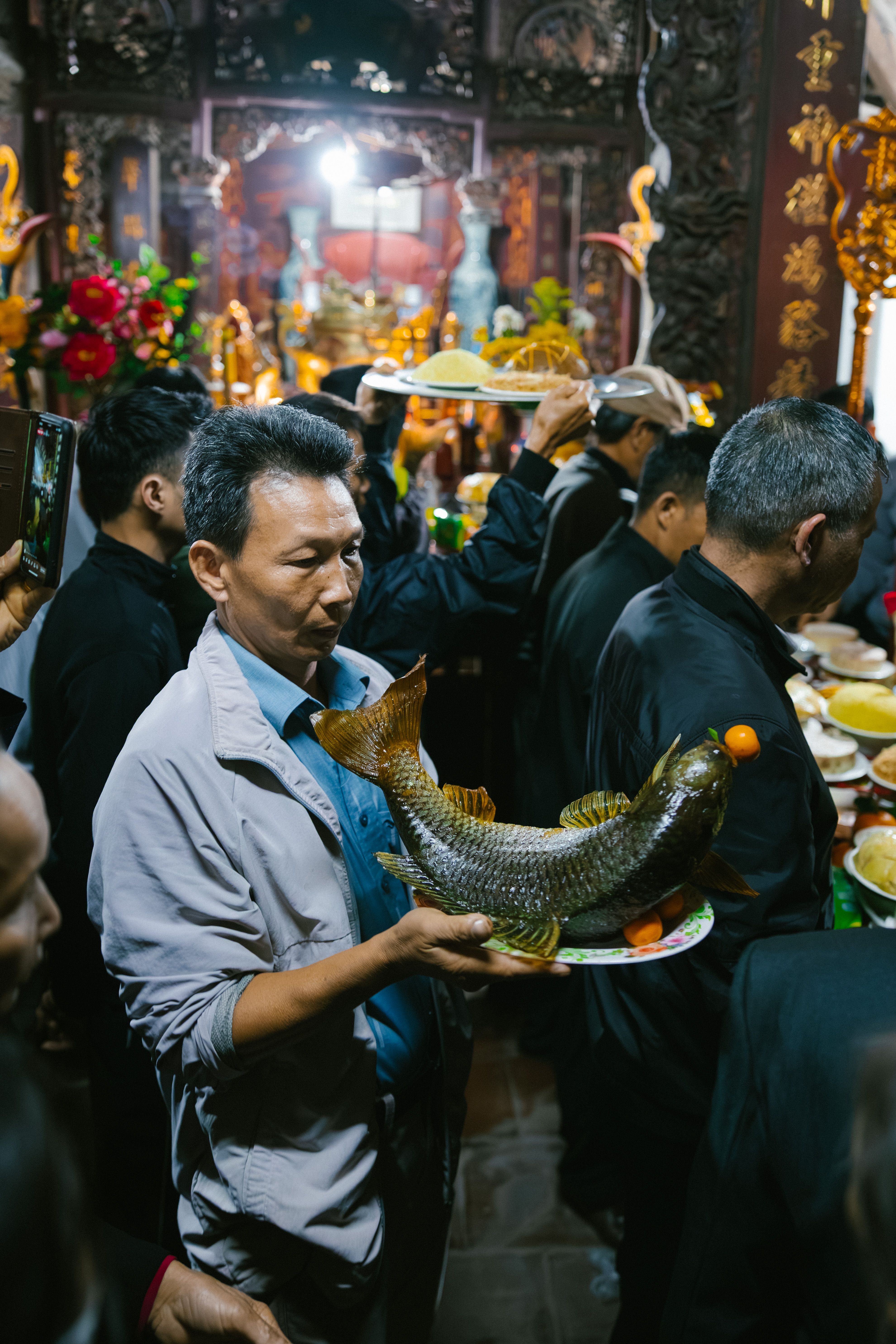 A vibrant cultural ceremony featuring traditional food offerings and ornate decorations.