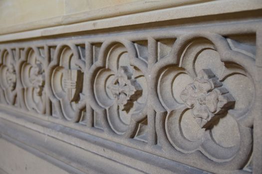Close-up of intricate stone carving patterns on a historic building facade.