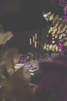 Luxurious dining setup with candles and floral decor, perfect for weddings and formal events.