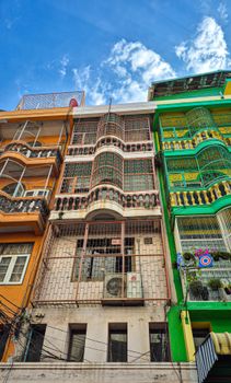 Vibrant multi-colored building facades in an urban Chinese neighborhood.