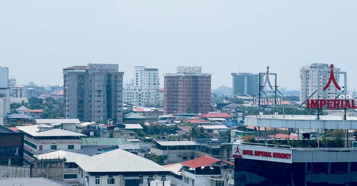 City view featuring the Imperial Regency Hotel and surrounding buildings under a clear sky.