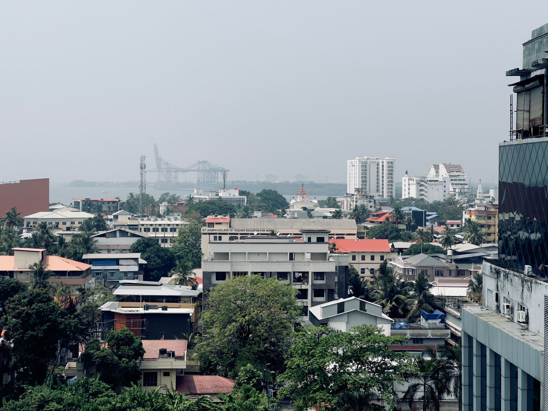 Cityscape with buildings and distant harbor view, showcasing urban life and architecture.