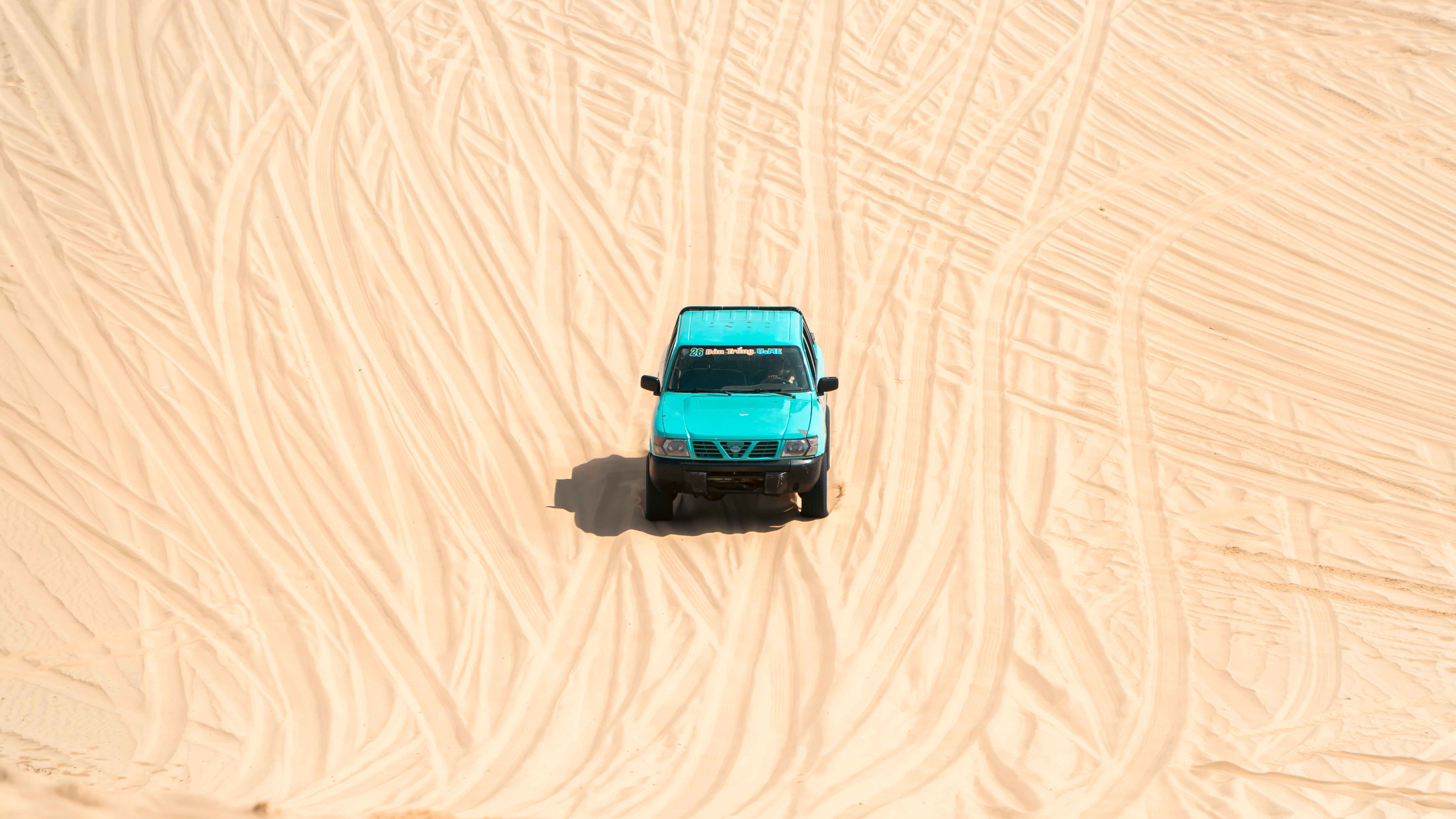 4x4 vehicle on sand dunes overlooking the Khor Al Adaid Inland Sea in Qatar