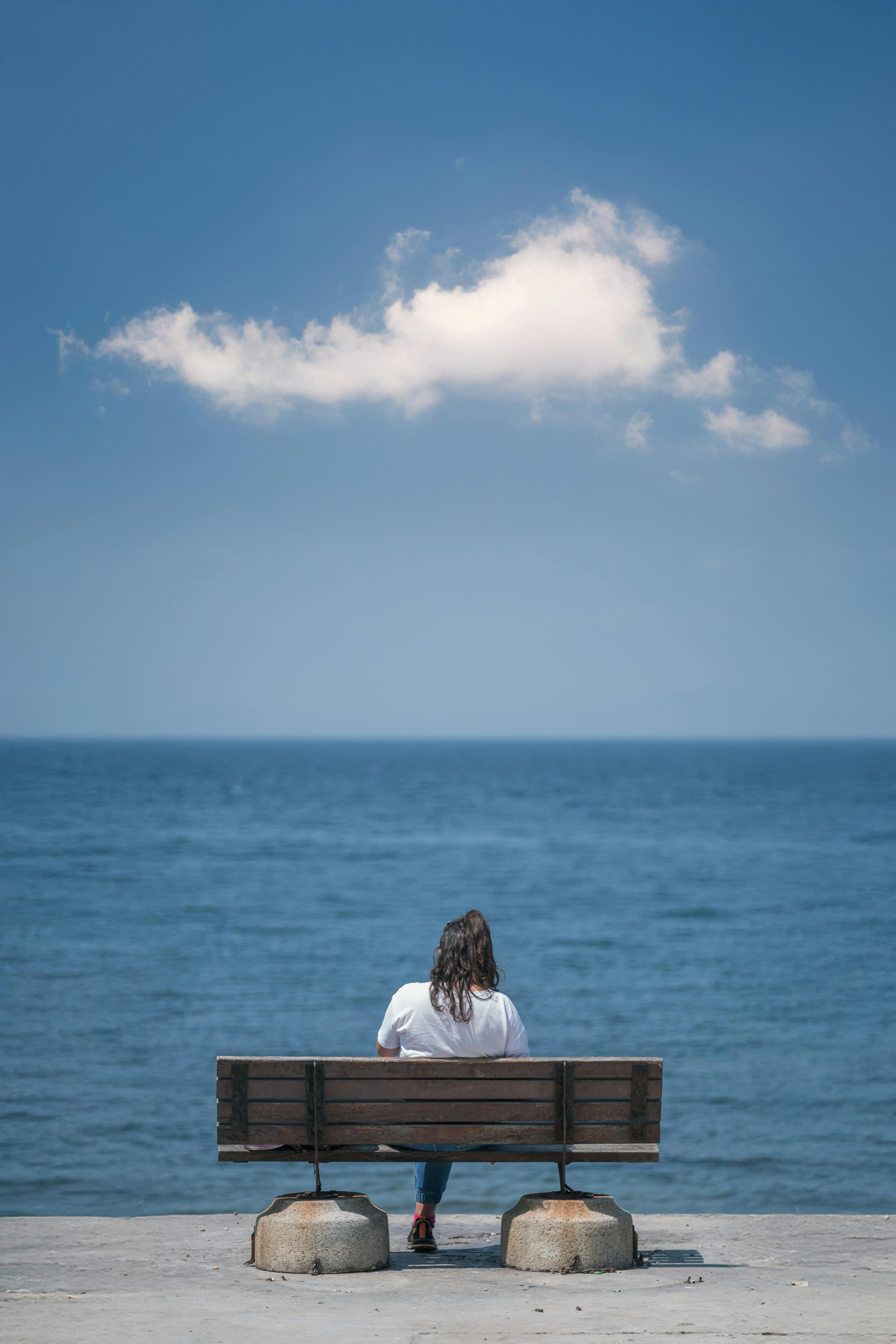 A person sitting alone by the sea