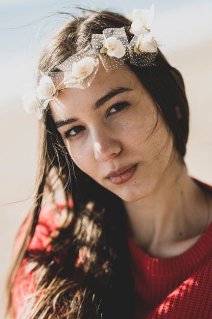 A beautifully captured portrait of a young woman with a white flower crown, blending elegance and nature.