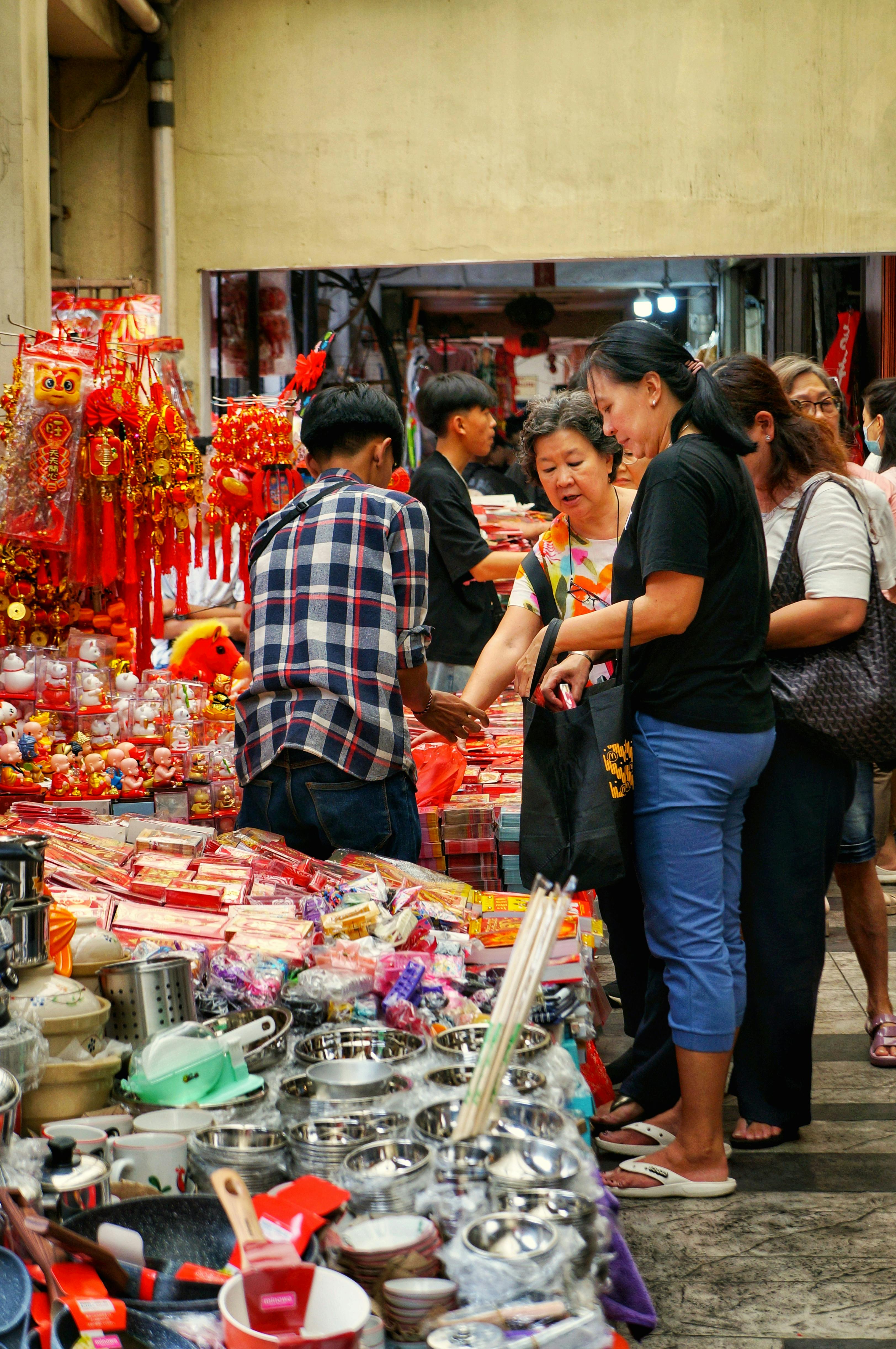 Colourful Singapore souvenirs including kaya jam, pineapple tart tins and Tiger Balm on display at a stall in Chinatown Street Market, Singapore