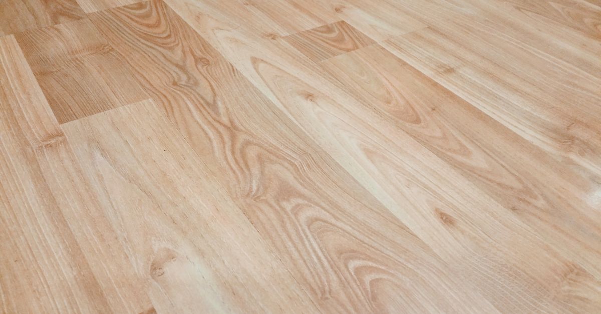 Smooth light brown wooden flooring with natural texture and patterns.