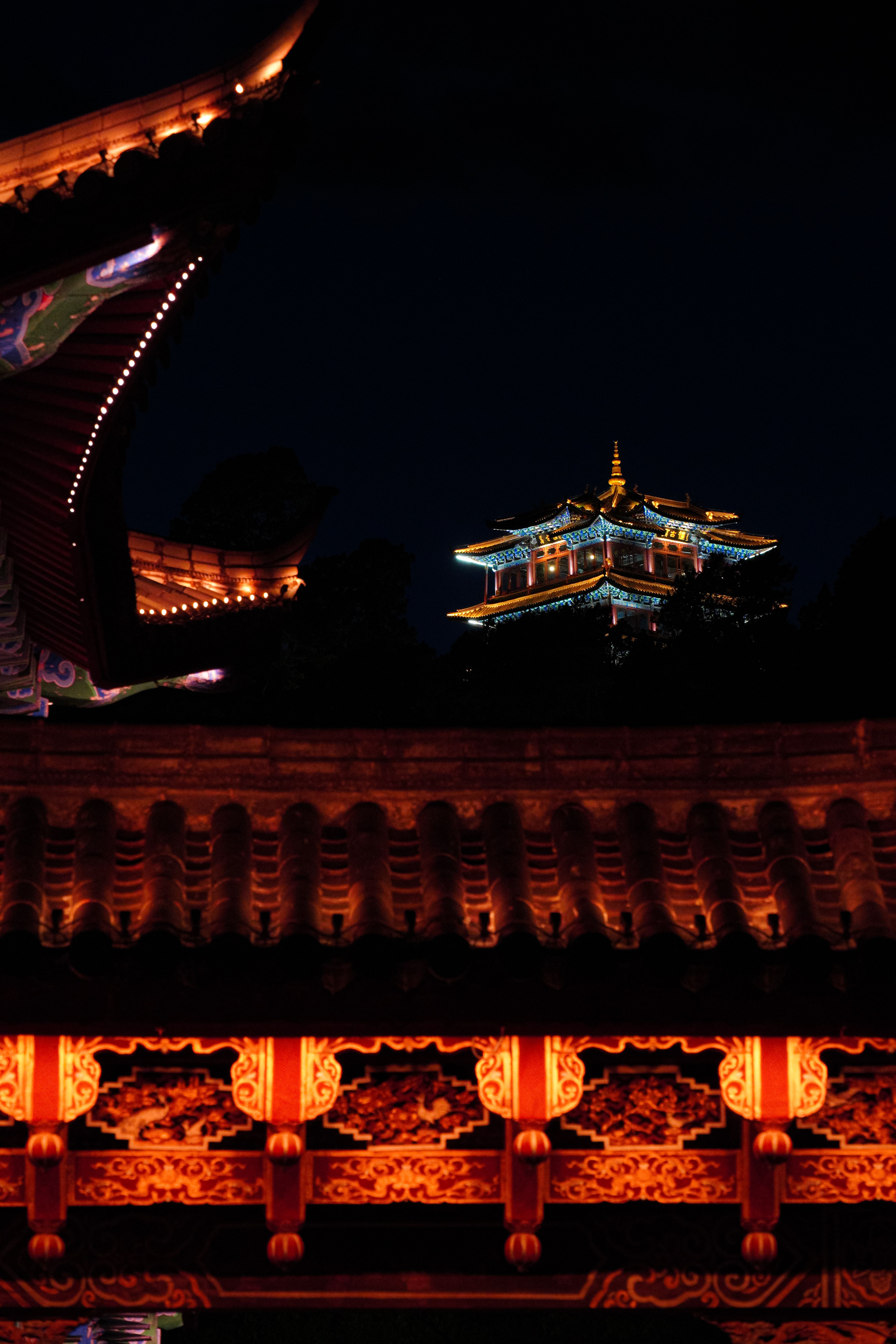 Captured at night, a beautifully lit pagoda in Lijiang, China, showcasing architectural elegance.