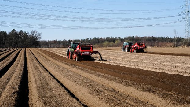 Tractors working on soil preparation in Wiershop, Germany during spring.