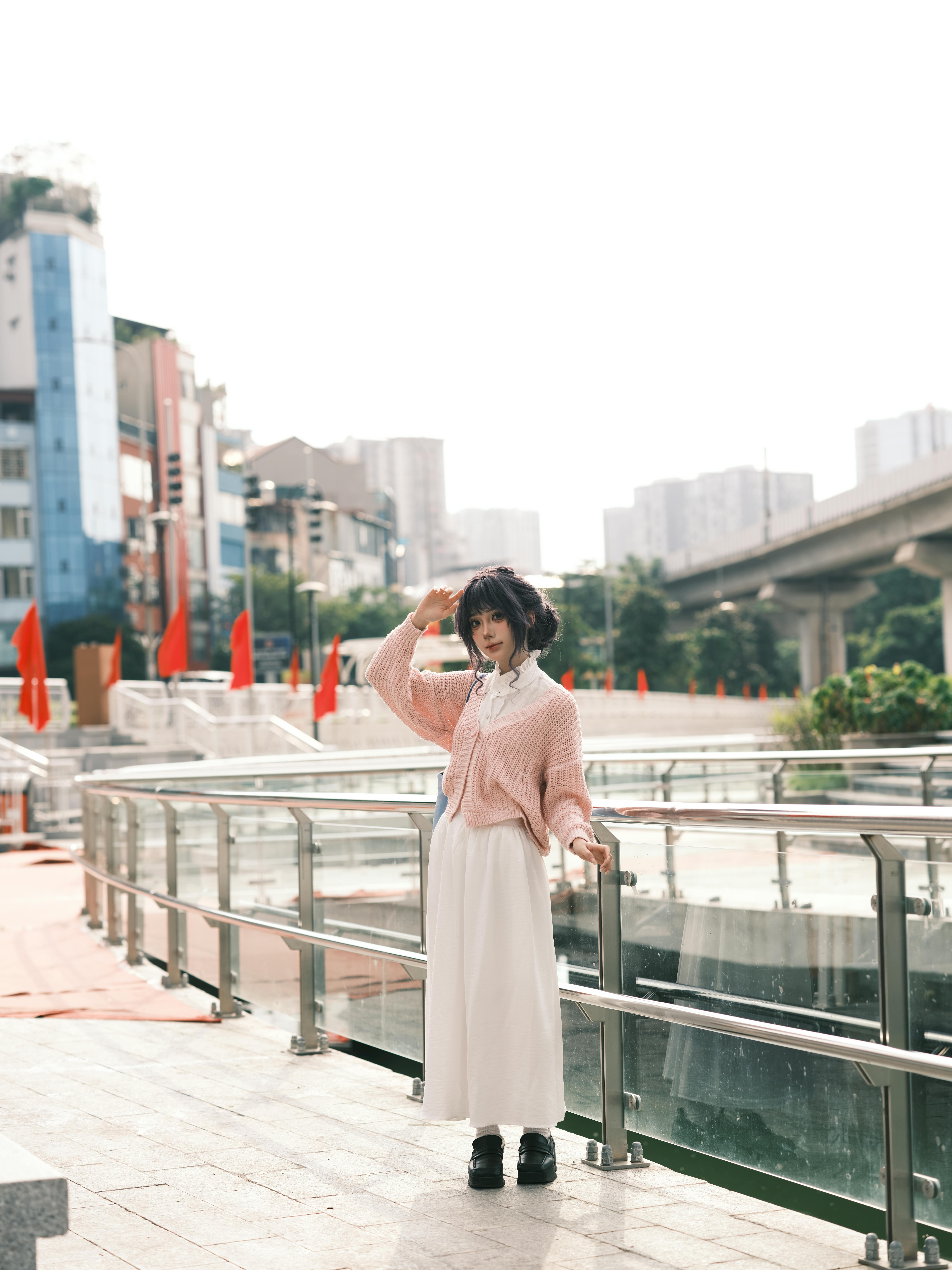A fashionable woman posing on a city balcony, capturing the essence of urban lifestyle and fashion.
