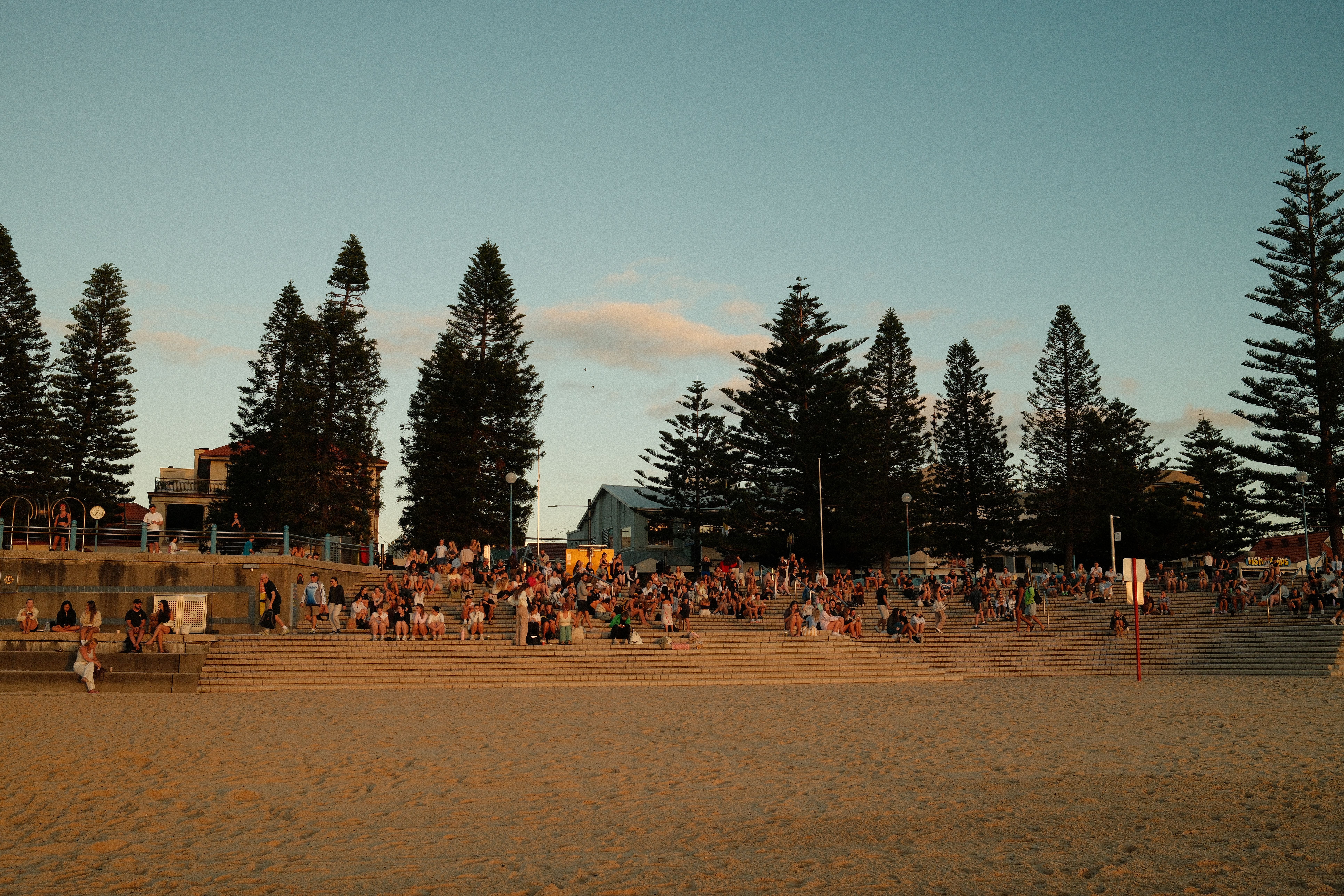 People using a free public BBQ at an Australian beach park