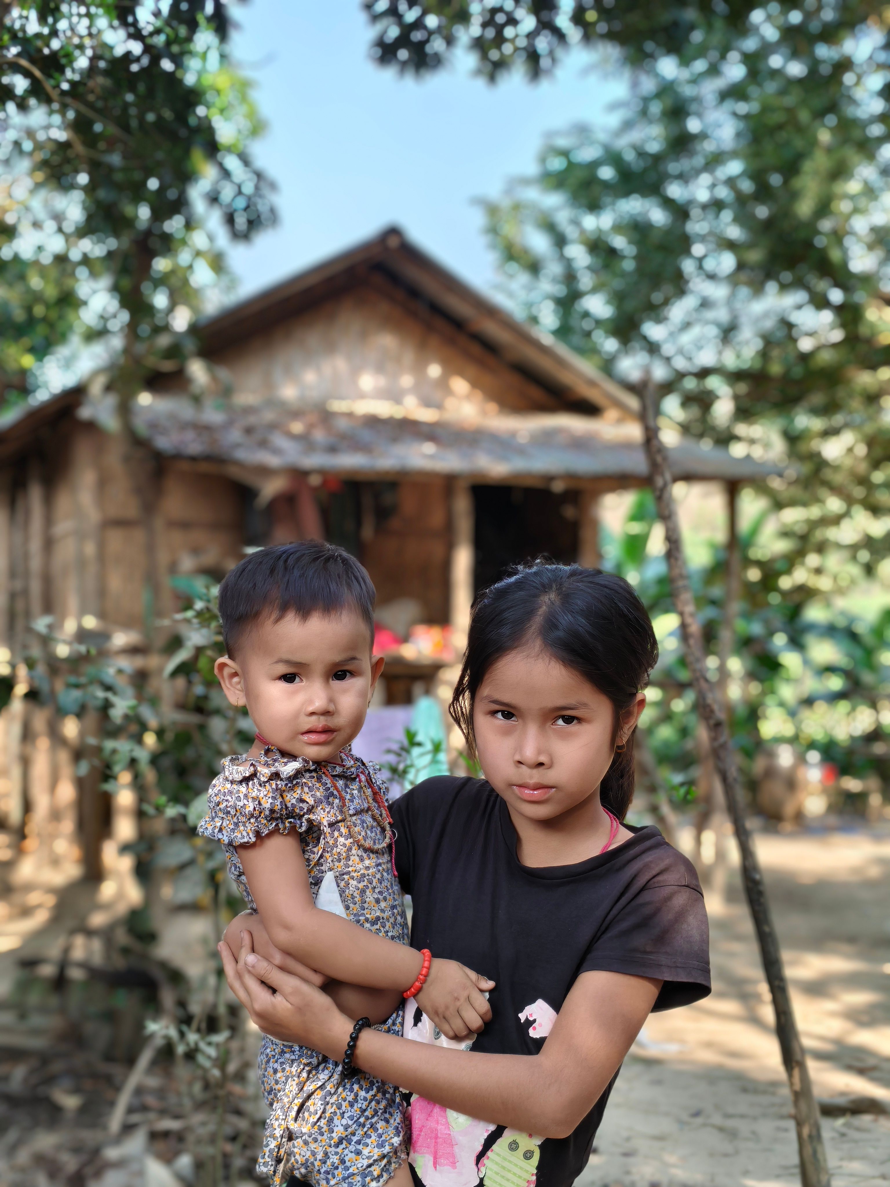 Rural Children in Front of Rustic Wooden House · Free Stock Photo