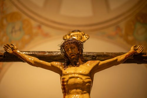Free Close-up of a detailed statue of Christ on the cross inside a church, showcasing religious art. Stock Photo