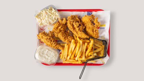 Free Crispy fried chicken, golden fries, coleslaw, and sauce served on a tray. Stock Photo