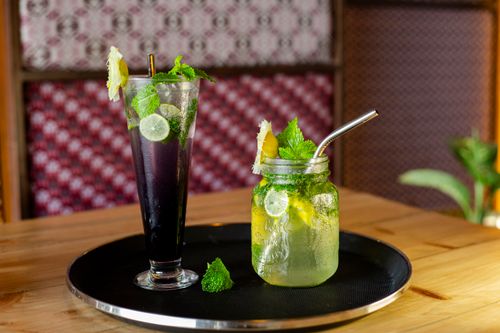 Free Two glasses of lemon and mint drinks on a wooden table, perfect for a summer refreshment. Stock Photo